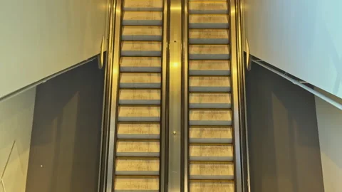 Escalators in a public building move between two levels at a shopping center Stock Footage 336580781
