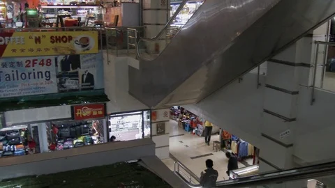 Escalators in a Shanghai mall, camera pans to see shops, 4K. Stock Footage 88058137