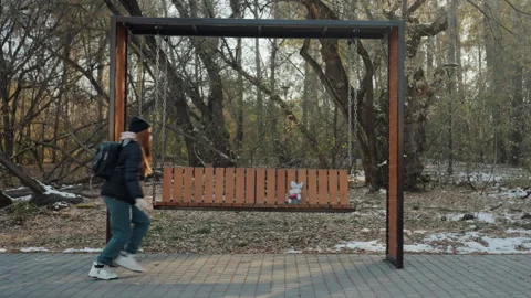 Escape from bench in snow. Swift dash through winter park after stolen item Stock Footage 332163887