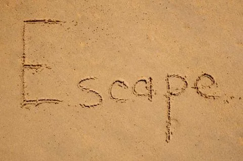 Escape message on the beach sand Photos