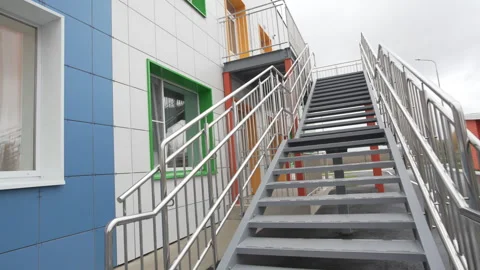 Escape staircase leading to upper level complements facade Vídeos de archivo 310604089