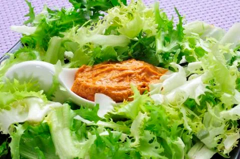 Escarole endive with romesco sauce, a typical salad from catalonia, spain Stock Photos