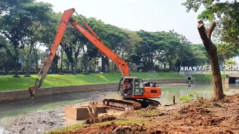 The Escavator digs the sediment in the river. Stock Footage 218213666