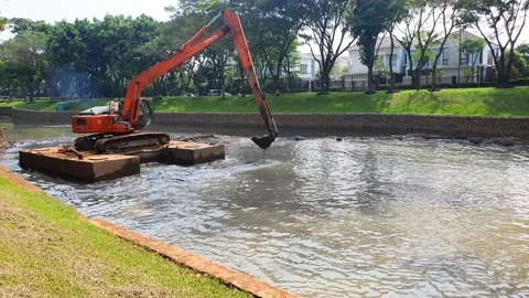 The Escavator digs the sediment in the river to prevent the flood Stock Footage 218213692