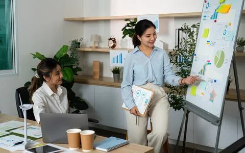 ESG Presentation. Businesswoman Explaining Data to Colleague in Office. Stock Photos