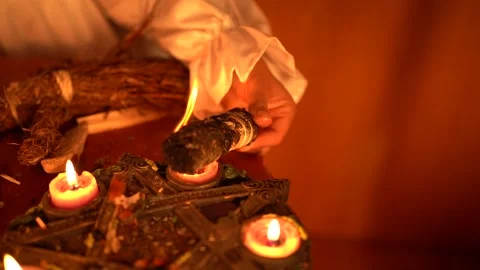 Esoteric ritual with burning candles and smoldering sage bundle, mystical Stock Footage 317223495