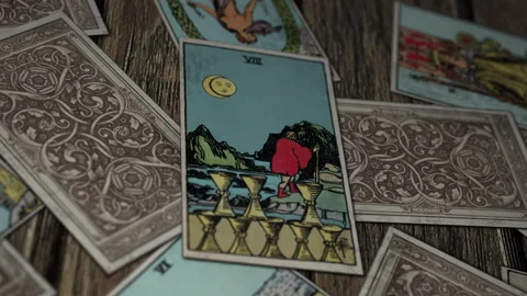 Esoteric witchcraft interpreting eight of cups card to divinate persons future Stock Footage 247228811