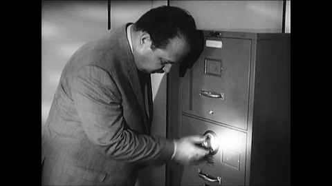 Espionage agents open a combination lock on a filing cabinet and photograph Stock Footage 88873952