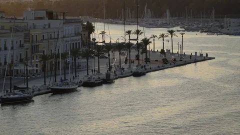 The esplanade at Brindisi viewed from a ship leaving the port at sunset Stock Footage 123477617
