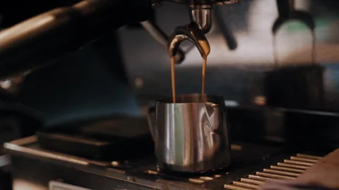 Espresso Being Poured Through Coffee Filter into Metal Cup 库存影片 307578688