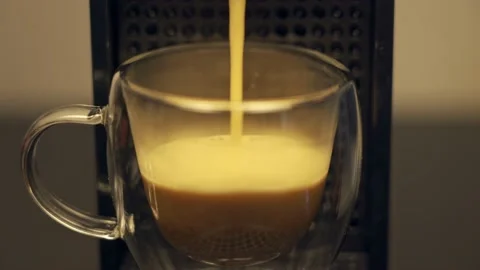 Espresso being poured into transparent cup in coffee machine Stock Footage 217680538