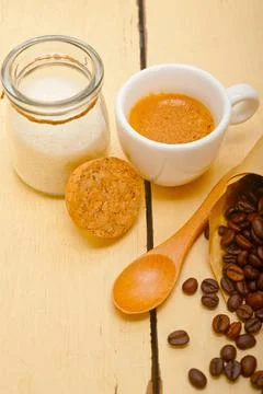 Espresso coffee and beans on a paper cone cornucopia over white background Stock Photos