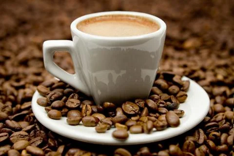 Espresso on Coffee Beans Stock Photos