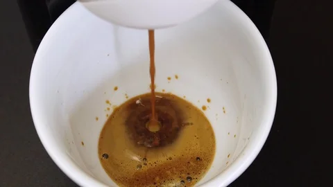 Espresso coffee brewing into a cup with a coffee machine Stock Footage 128031458