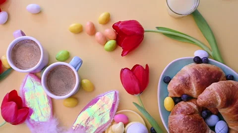 Espresso coffee in bright cups, Easter chocolate eggs, croissants Stock Footage 146872370