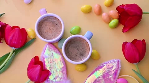 Espresso coffee in bright cups, Easter chocolate eggs, pink rabbit Stock Footage 146872374