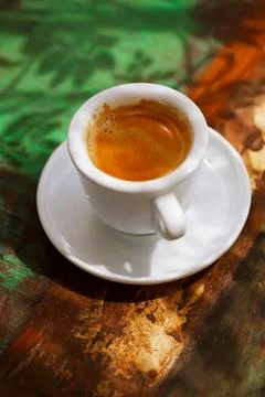 Espresso coffee cup on rustic table with sun Stock Photos