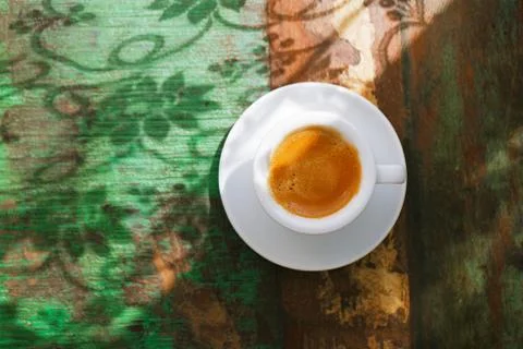 Espresso coffee cup on rustic table with sun Stock Photos