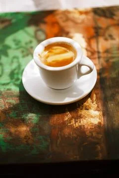 Espresso coffee cup on rustic table with sun Stock Photos