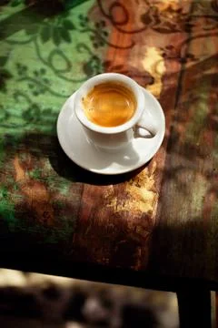 Espresso coffee cup on rustic table with sun Stock Photos
