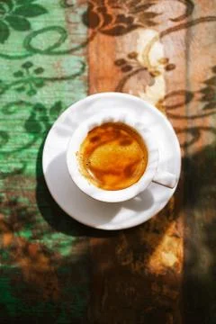 Espresso coffee cup on rustic table with sun Stock Photos