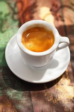 Espresso coffee cup on rustic table with sun Stock Photos