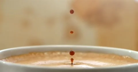 Espresso coffee drop creating a splash and ripple in crema, super slow motion Stock Footage 344848561