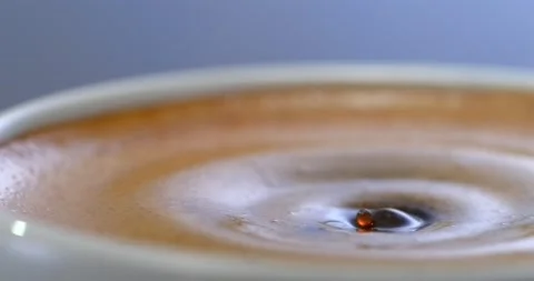 Espresso coffee drop creating a splash and ripple in crema, super slow motion Stock Footage 344849207