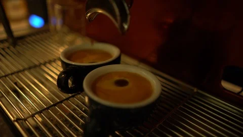 Espresso coffee drop into the filled 2 Cups from the coffee machine Stock Footage 125927421