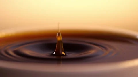 Espresso coffee drop into the filled Cup from the coffee machine in slow motion Stockbeeldmateriaal 139875012