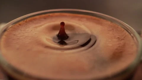 Espresso coffee drop into the filled Cup from the coffee machine in slow motion Video stock 168329586