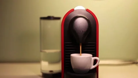 Espresso coffee machine with capsules pouring coffee in a cup Stock Footage 139061206