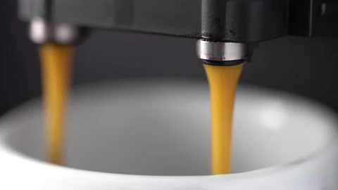Espresso coffee machine pouring coffee and milk into a cup Stock Footage 140581445