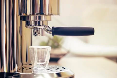 Espresso coffee machine on a table, coffee brewing, appliances. Stock Photos