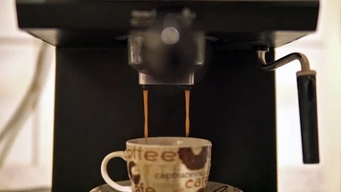 Espresso coffee made with coffee machine, coffee falls into a cup from porcelain Stock Footage 99843199