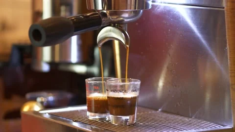Espresso coffee. Making espresso coffee pouring shots on using 2 spout Stock-Footage 166932004