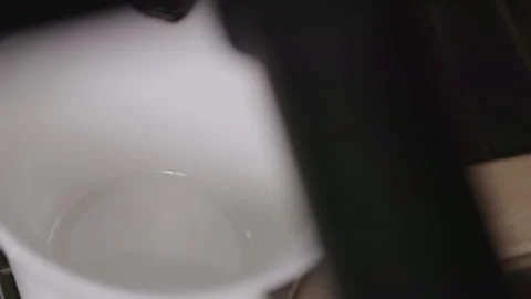 Espresso coffee poured in cup in slow motion Stock Footage 130574859