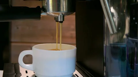 Espresso coffee is poured into a white cup Stock-Footage 122064482