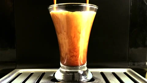 Espresso coffee preparing a drink in a coffee machine close-up. A transparent gl Stock Footage 131609069