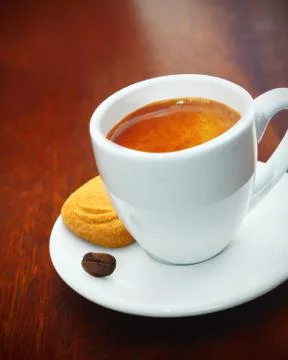 Espresso coffee served with a biscuit Stock Photos