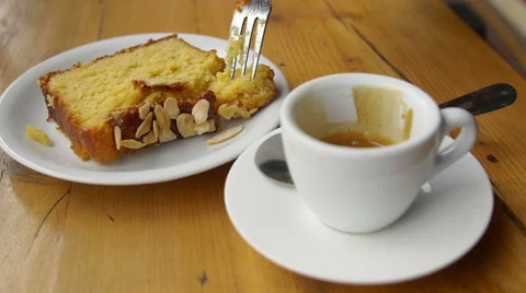 Espresso coffee with a slice of cake: breakfast, cafe, England, dessert Stock Footage 53609302