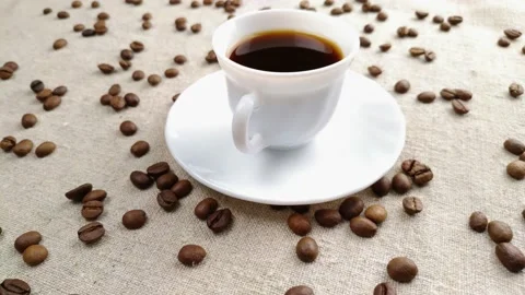 Espresso coffee in a small white cup on a light background of a textile napkin Video stock 150938984