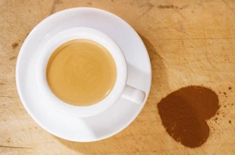 Espresso coffee in thick white cup with cocoa heart Stock Photos