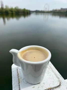 Espresso cup near a lake Stock Photos