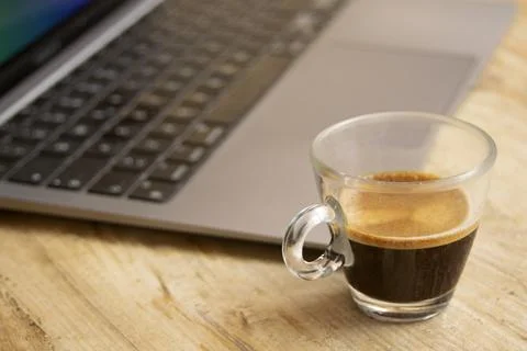 Espresso cup next to laptop screen displaying pause text for work break Stock Photos