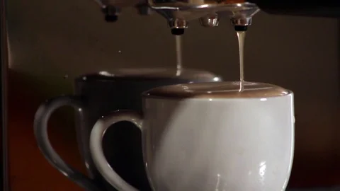 Espresso dripping on a full cup of Espresso and Foam slow drip from a double 스톡 동영상 81456005