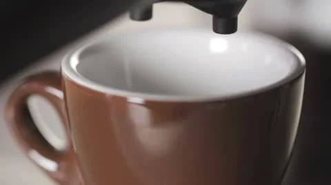Espresso flowing from a machine into a cup Stock Footage 24672377