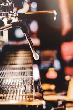 Espresso machine brewing a coffee. Coffee pouring into glasses in coffee shop Stock Photos