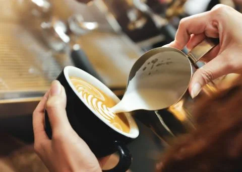 Espresso machine brewing a coffee. Coffee pouring into glasses in coffee shop Stock Photos