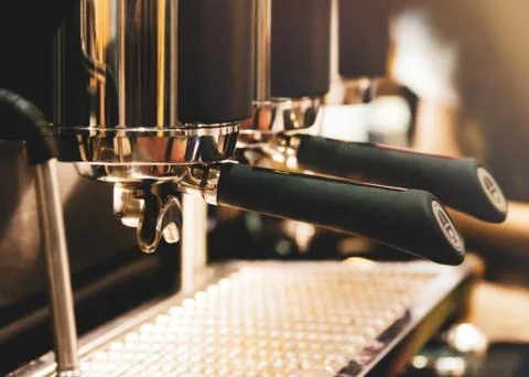 Espresso machine brewing a coffee. Coffee pouring into glasses in coffee shop Stock Photos